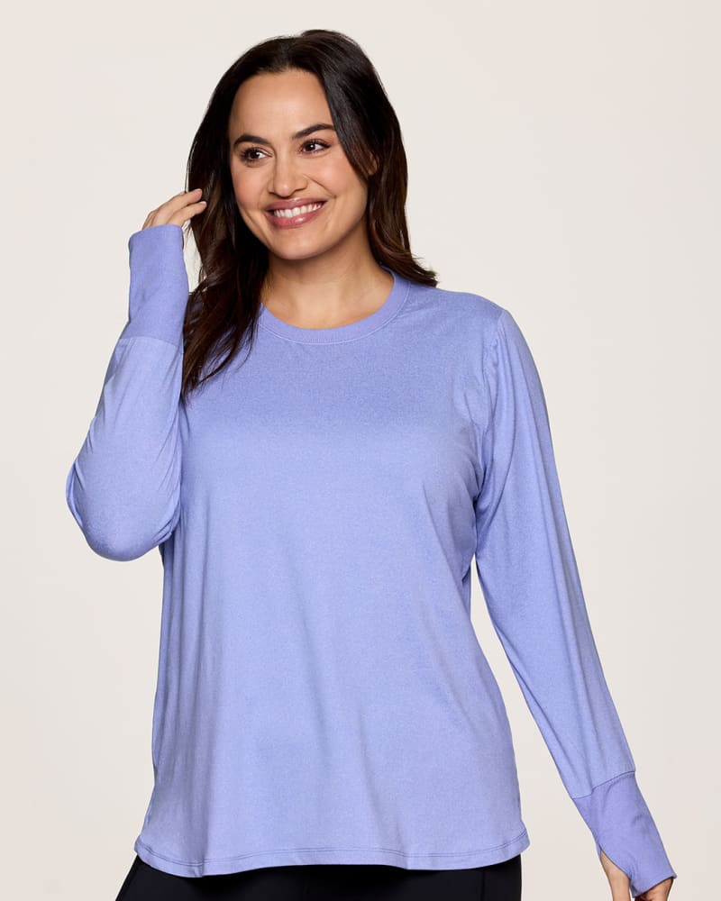 Front of a model wearing a size 1X Plus Studio Super Soft Tunic Tee in Purple by RBX Active. | dia_product_style_image_id:341659